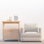 Elegant minimalist living room featuring sofa, side table with clock.
