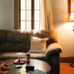 A warm, inviting living room interior featuring a sofa, coffee table, and floor lamp.