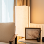 Modern cozy living room corner with a soft chair and ambient lighting.