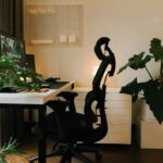 A stylish home office setup with plants and ergonomic chair, perfect for a productive work environment.