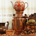 Beautiful display of copper tea set with exotic fruits, showcasing a blend of culture and refinement.