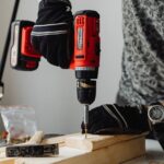 A skilled craftsman working on a wooden piece using a power drill, showcasing precision and expertise.
