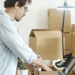 Businessman packing products in a home office for an online store startup.