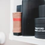 Stylish bottles with male perfume and cologne placed on shelf in light bathroom