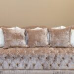 Luxurious beige sofa adorned with plush cushions in a stylish interior setting.